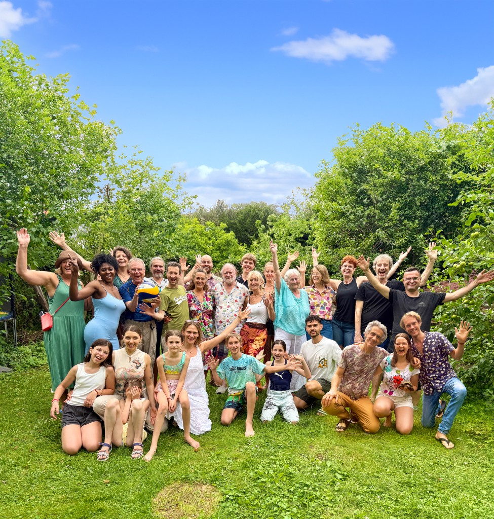 The sangha gathered in the garden, hands raised in celebration