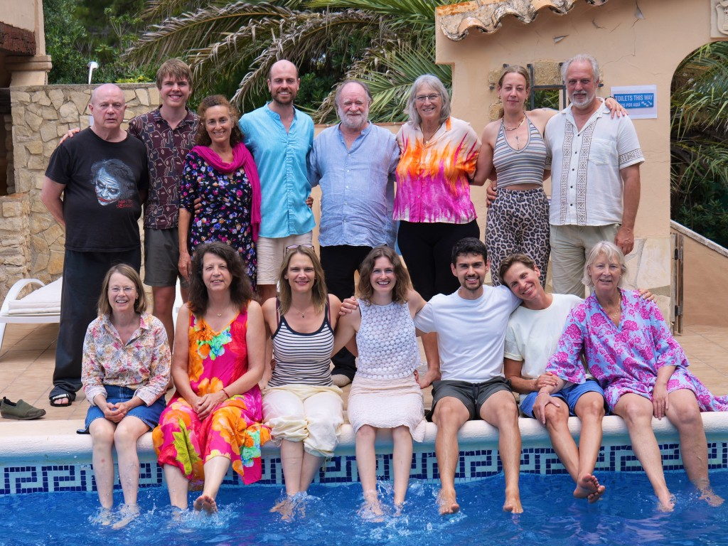 Retreat group sitting together at the edge of the pool