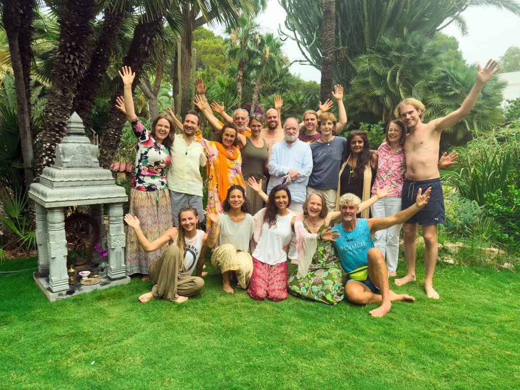 Retreat group in the garden beside a stone shrine