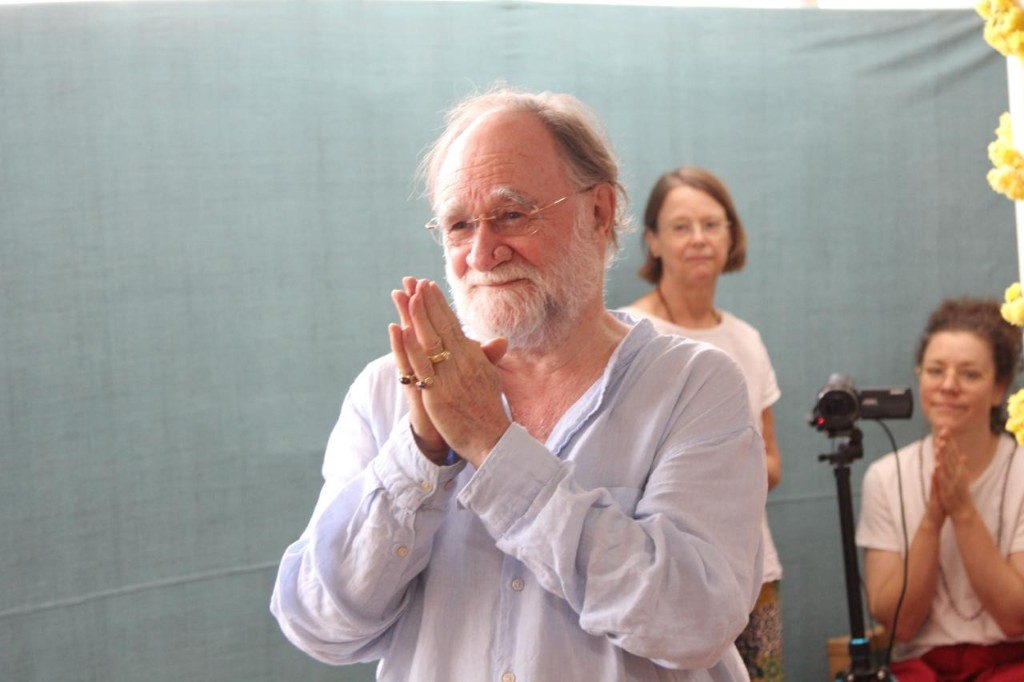 John David greeting the gathering with hands in namaste