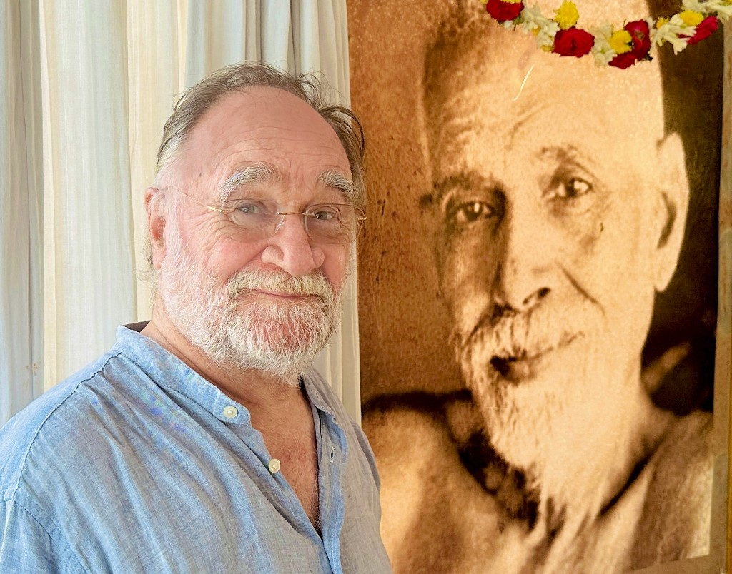 John David beside a garlanded portrait of Sri Ramana Maharshi